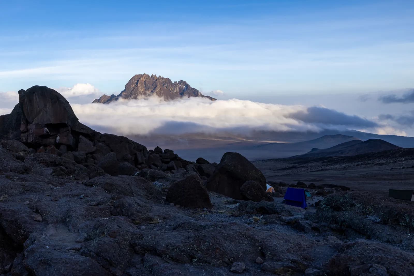 Mount kilimanjaro summit landscape with rocky terrain and clouds at sunrise for adventure travel