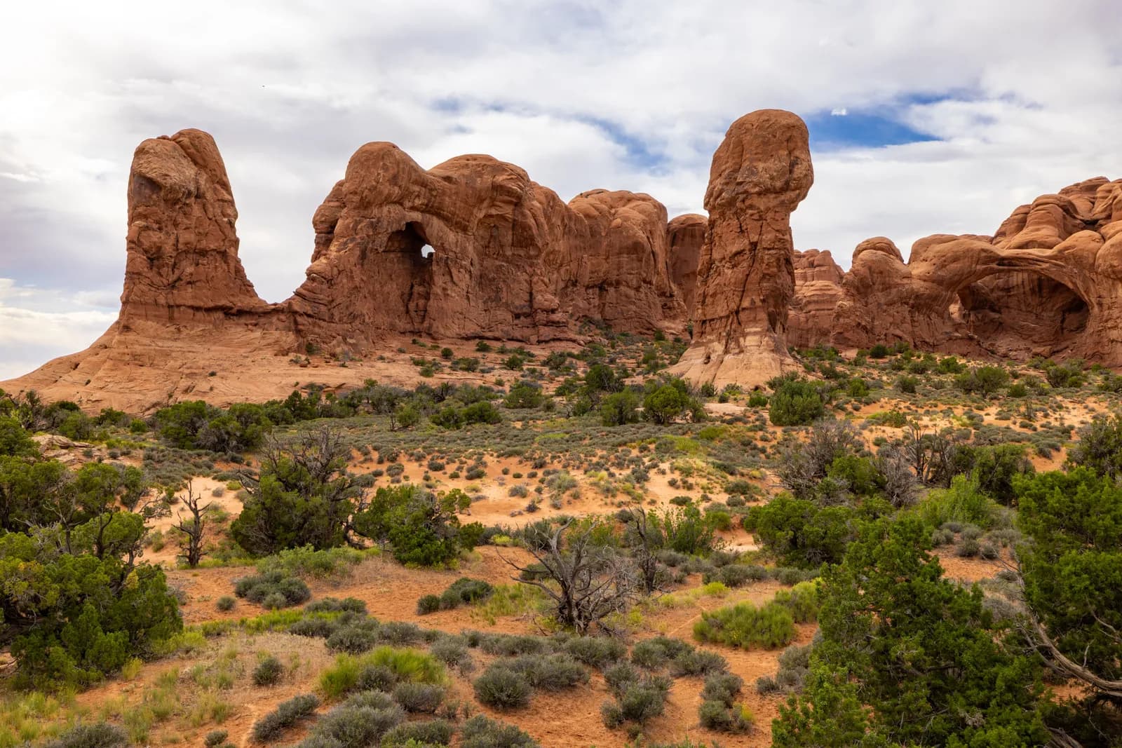 Scenic view of red sandstone rock formations in arches national park utah during a cloudy day