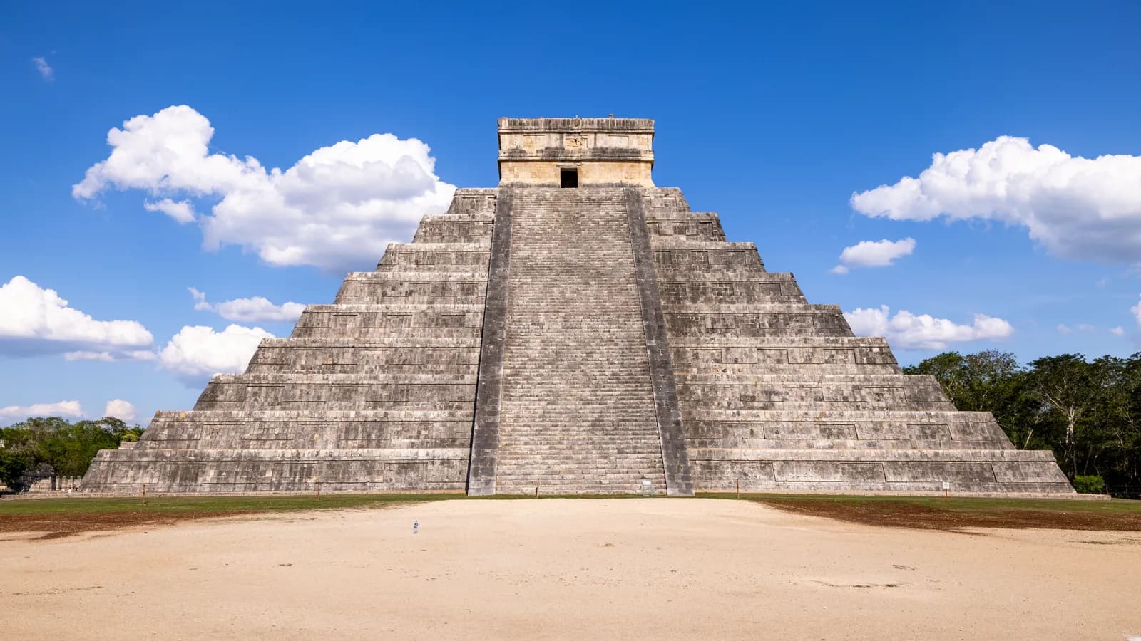 Ancient mayan pyramid of chichen itza under a bright blue sky in mexico