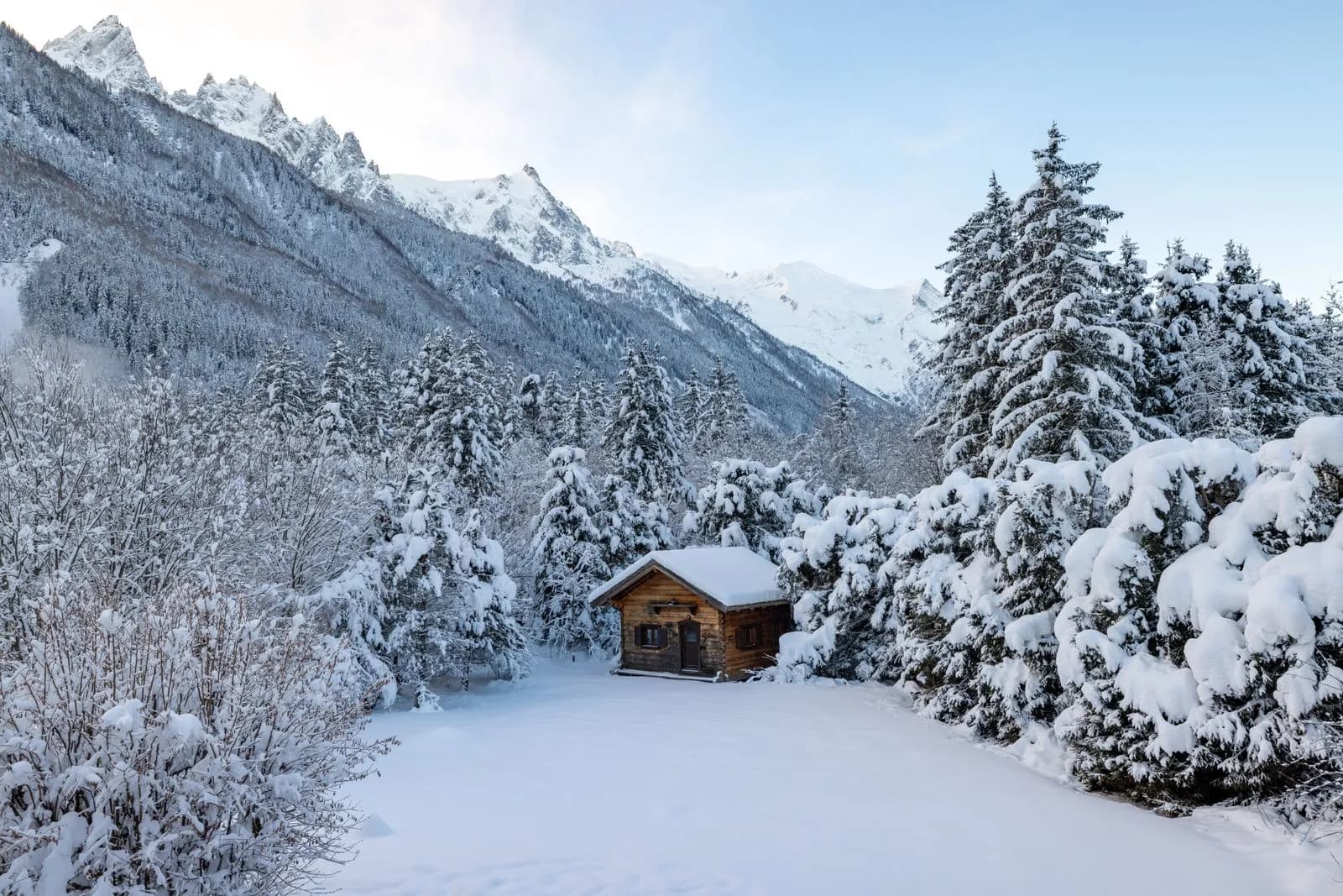 Small wooden cabin in snowy mountain landscape during winter season for travel and holiday background