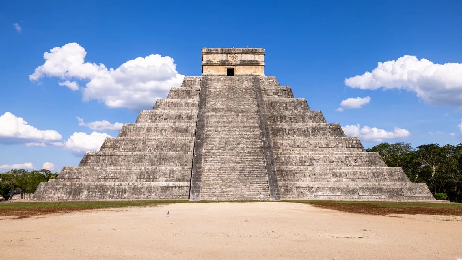 Ancient mayan pyramid of chichen itza under clear blue sky in mexico