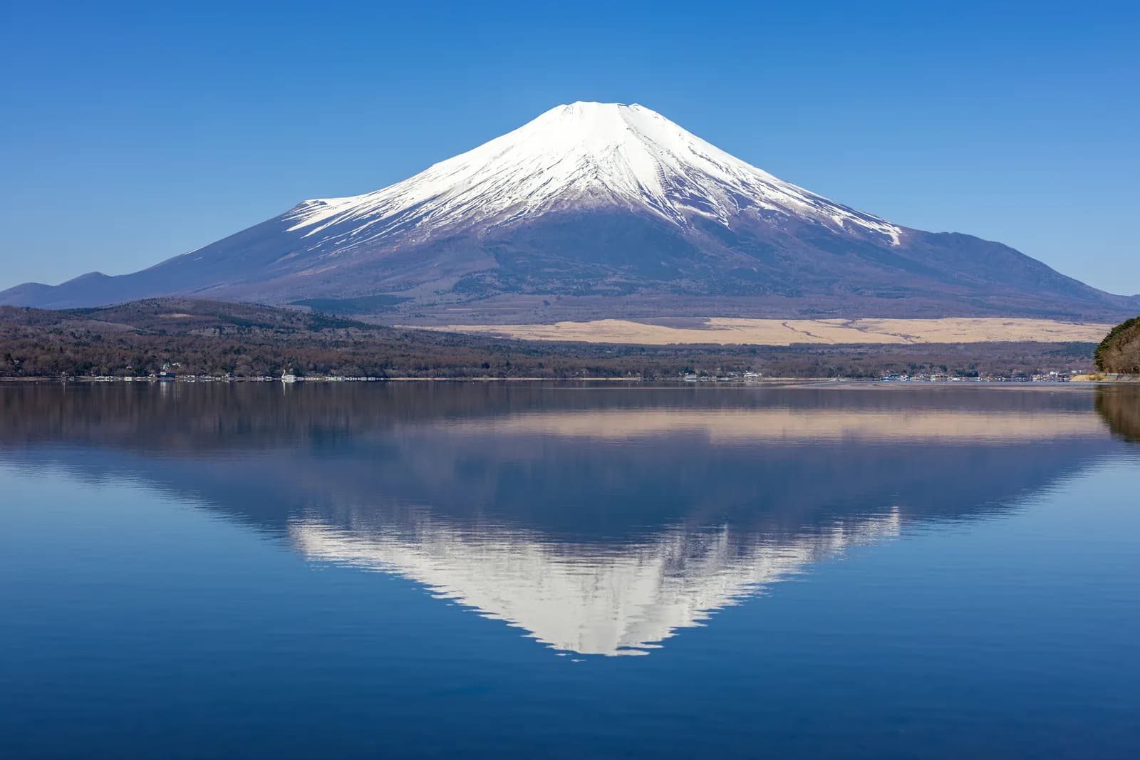 Scenic view of mount fuji with snow capped peak reflecting in lake yamanaka japan