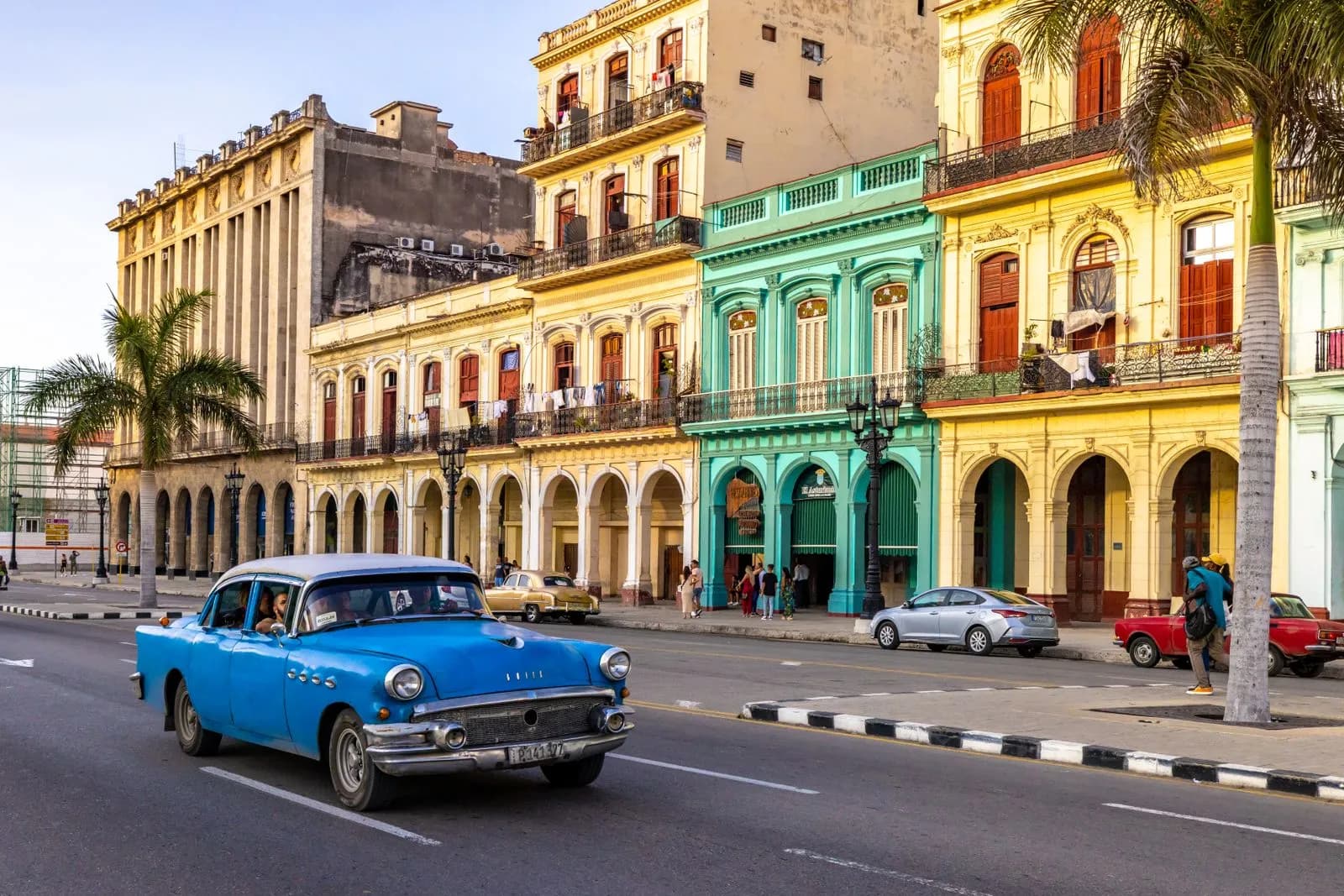 Vintage blue classic car driving on a street in old havana cuba with colonial architecture