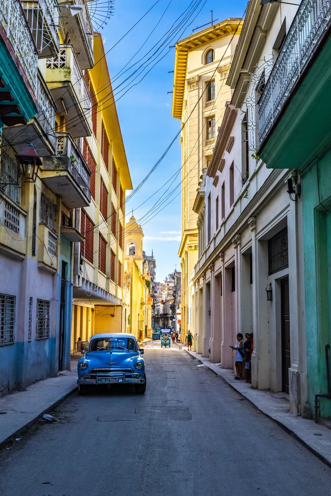 Classic blue vintage car parked on a narrow street in old havana cuba city center