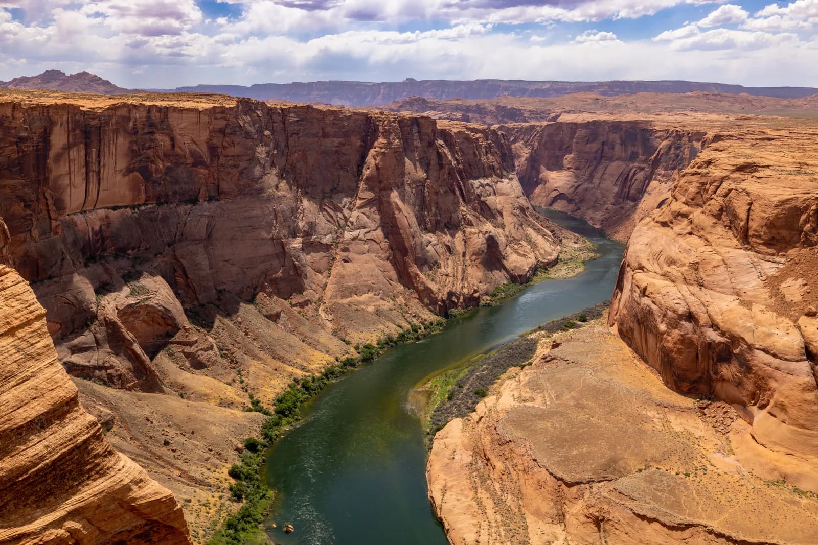Scenic view of colorado river winding through deep sandstone canyon walls in arizona desert landscape