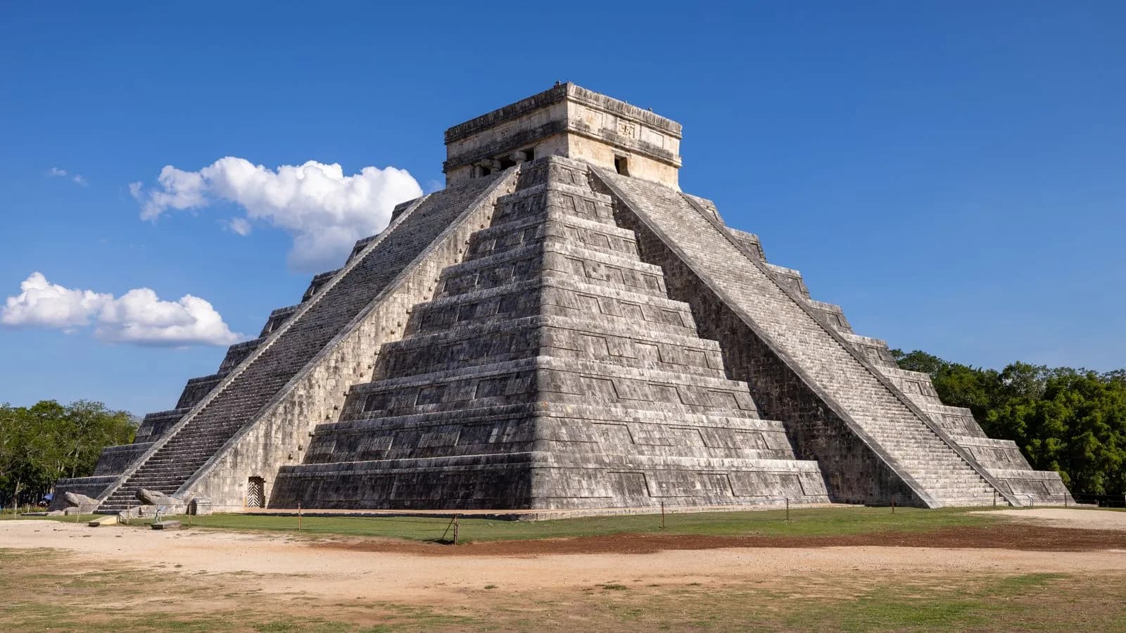 Ancient mayan pyramid of chichen itza under clear blue sky in mexico travel destination landmark