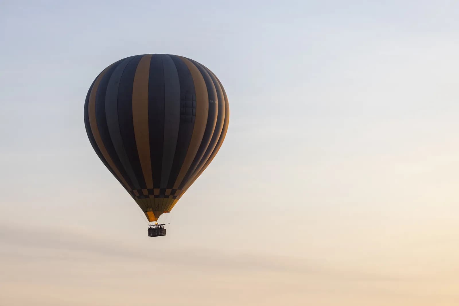 Hot air balloon flying in the clear morning sky for travel and adventure tourism concept