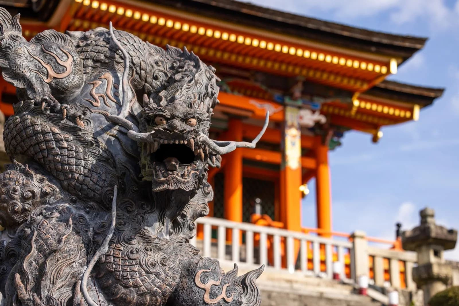 Traditional stone dragon statue at a historic Japanese temple in Kyoto during a sunny day