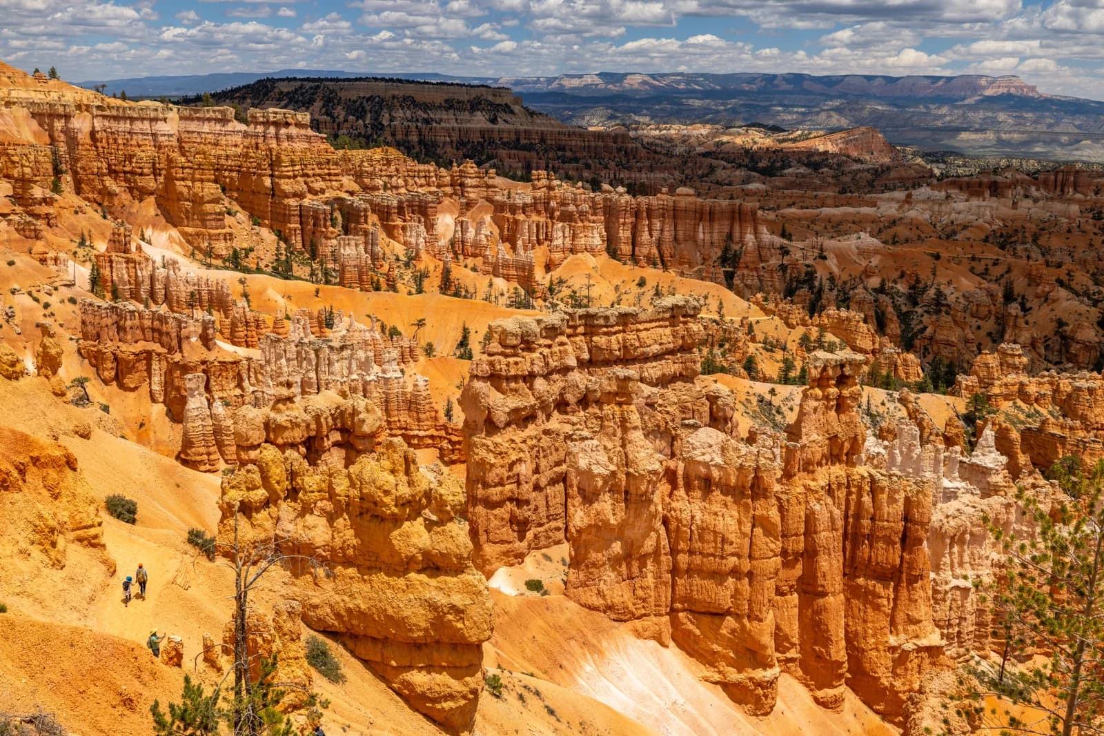 Scenic view of bryce canyon national park with hikers on a trail in utah during a sunny summer day