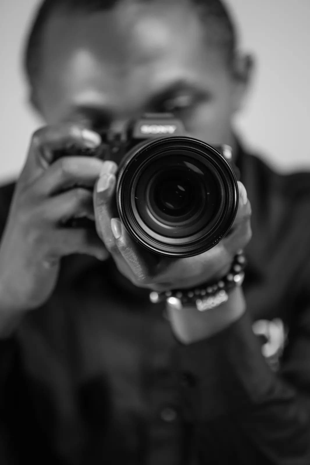 Professional photographer holding a camera to take a picture in a studio setting